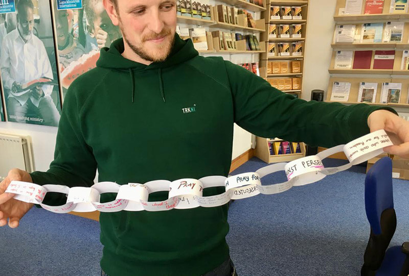 LMI Youth and Schools Outreach Worker showing the Paper Prayer Chain from the YSO youth event.